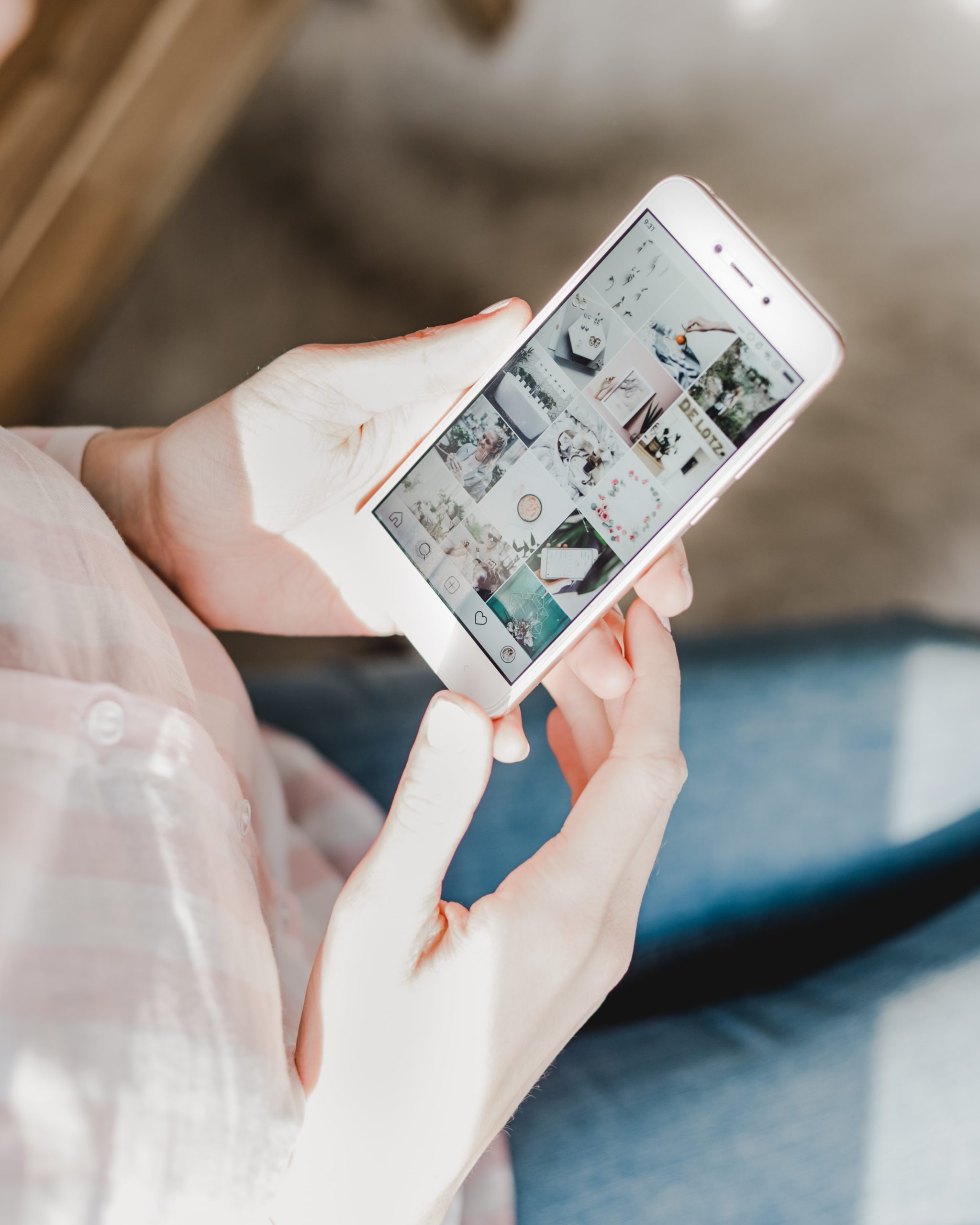 Close Up of Woman's Hands Holding Smartphone with Instagram Feed on Screen