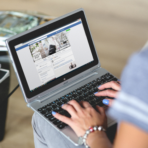 Woman's Hands on Acer Laptop Keyboard, Facebook Profile on Screen