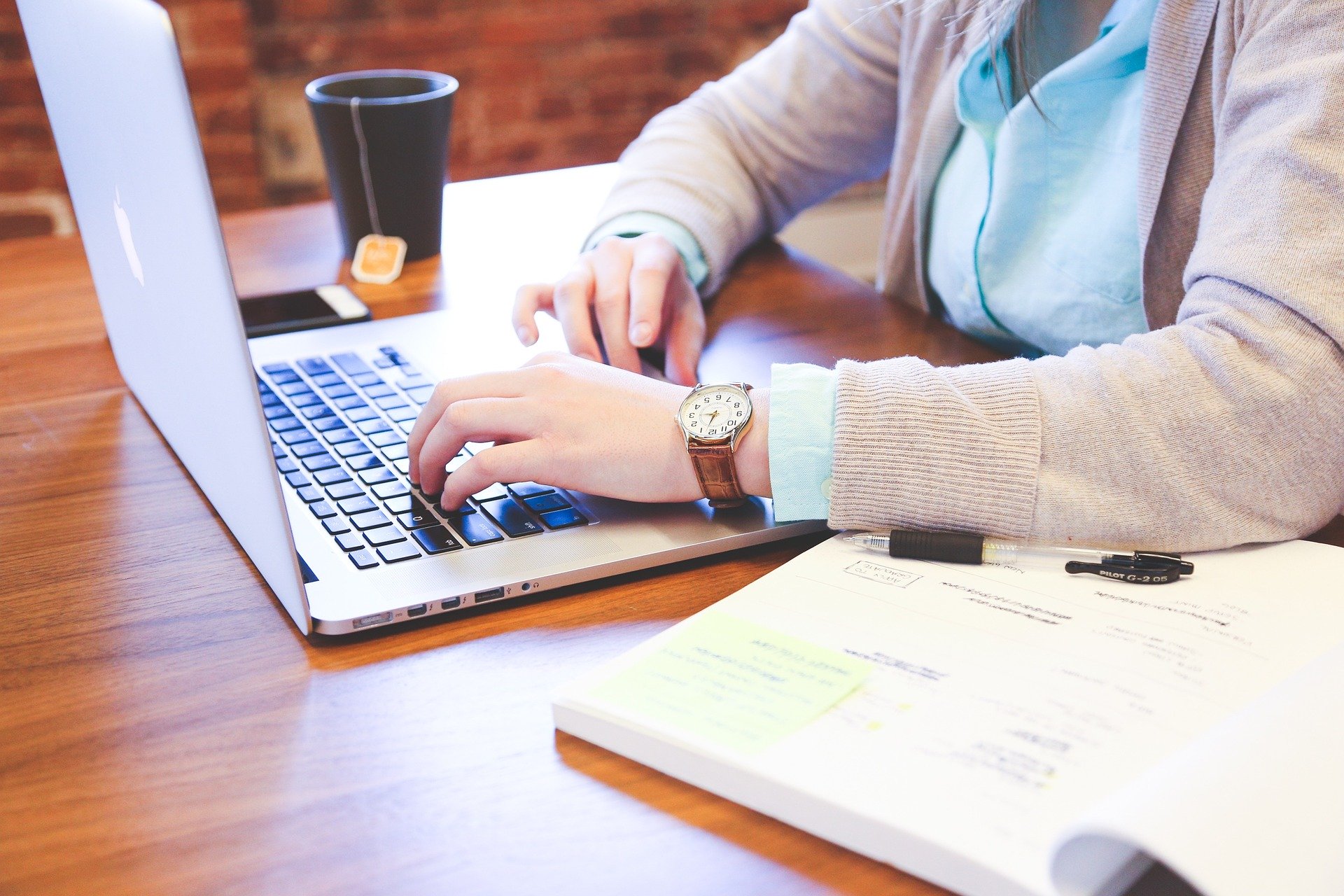 Woman with hands on MacBook Pro Keyboard