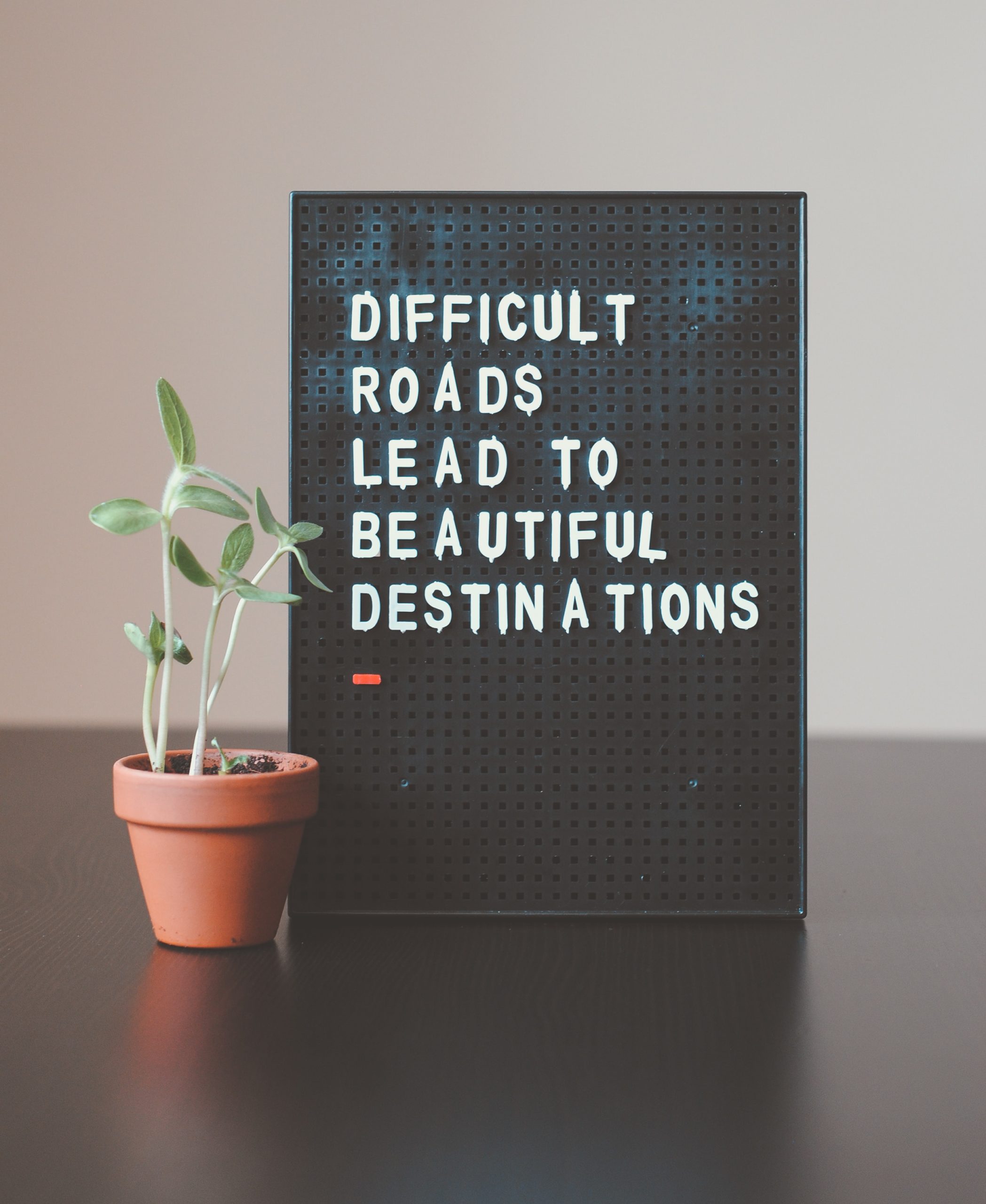 Black Letter Board Saying "Difficult Roads Lead to Beautiful Destinations"