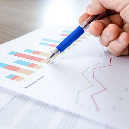 Analytics Reports on printed paper with blue pen