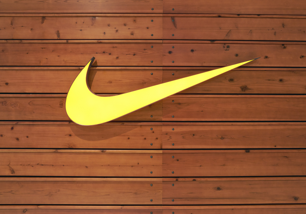 Yellow Nike Swoosh on Wooden Wall