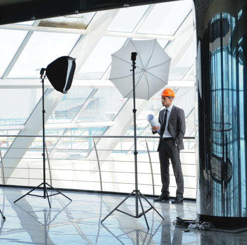 Architect posed with photography lighting in modern building